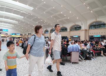 China reports 735 mln railway trips during summer travel rush